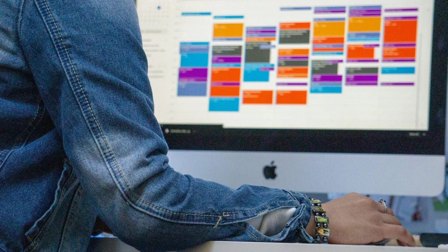 Person viewing a digital content calendar on a desktop computer.